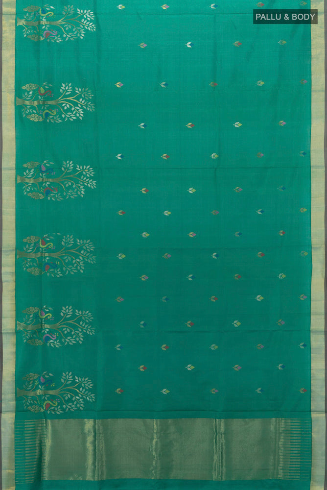 Flat view of Peacock Blue Uppada Silk Saree with Zari Butta on the body and Silk Border. 