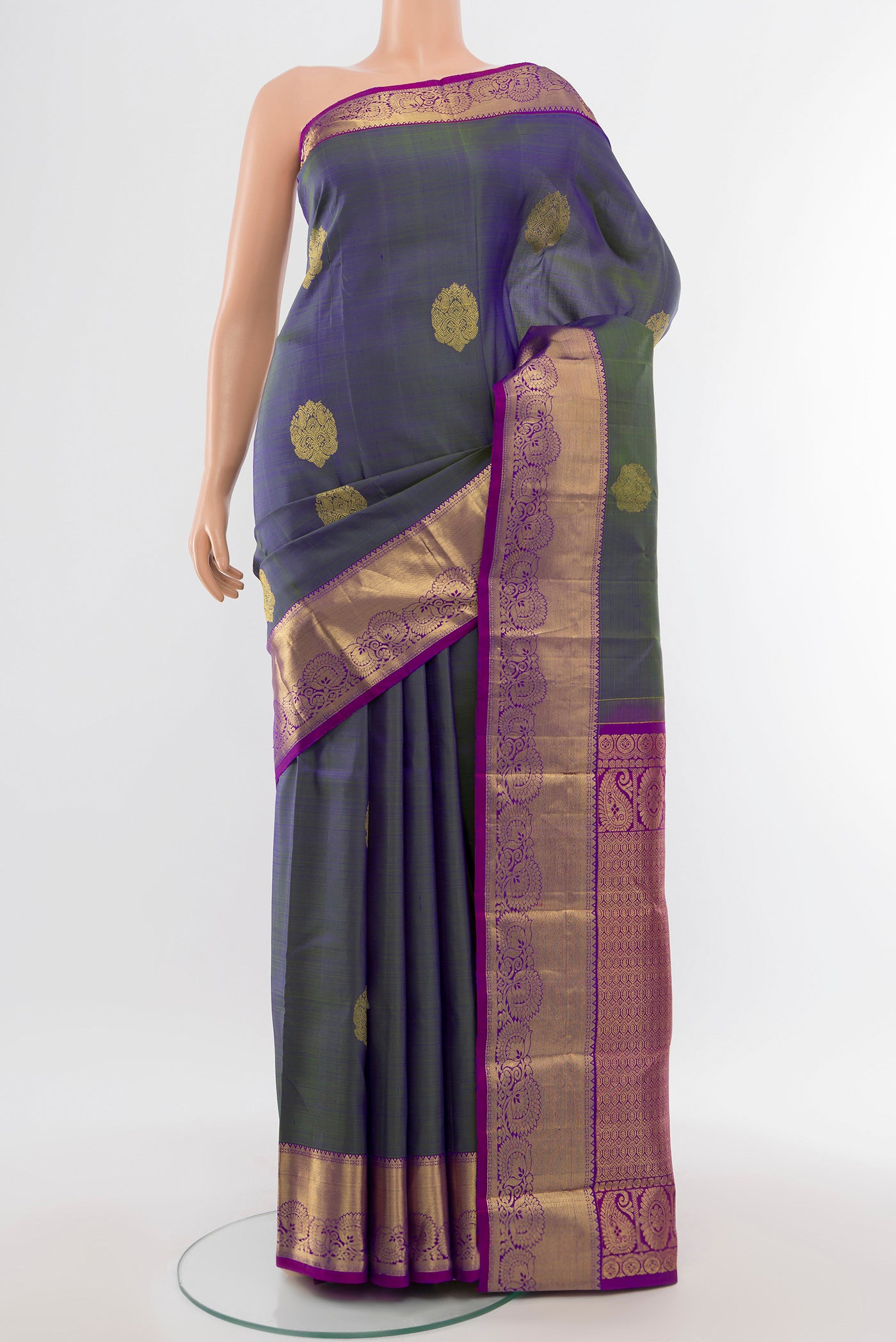Pure Silk Pure Zari Light Blue Kanchipuram Saree with Zari Butta on the body and Silk Border.  displayed on a mannequin