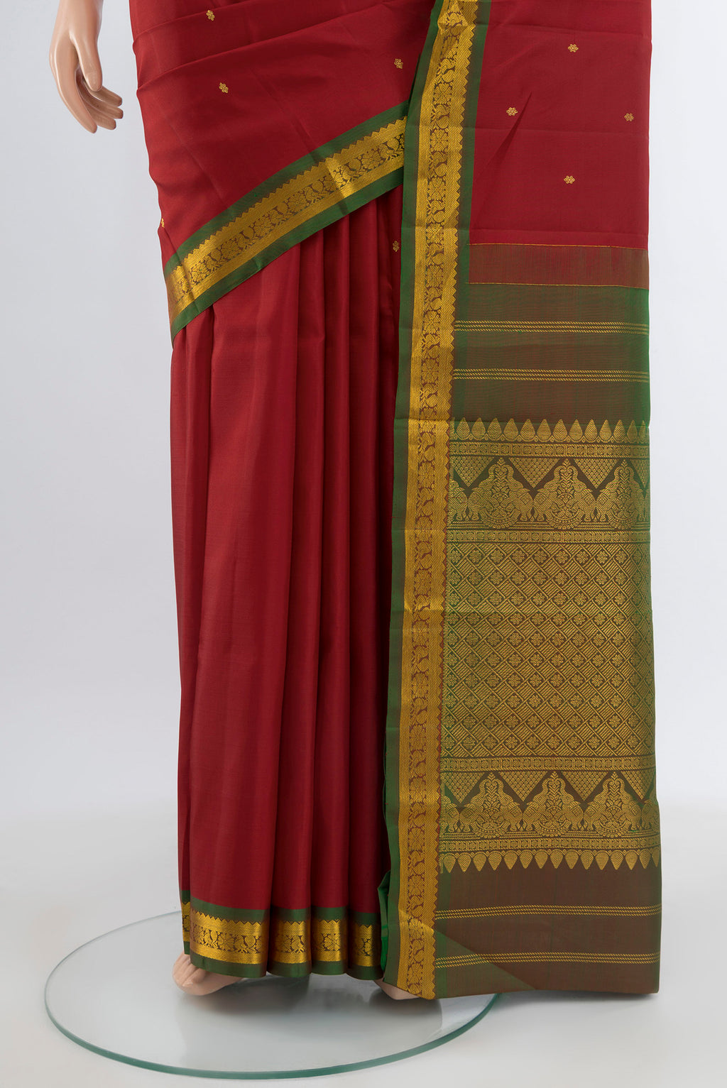Pleats and pallu of Red Kanchipuram Silk Saree with Zari Butta on the body and Zari Border. 
