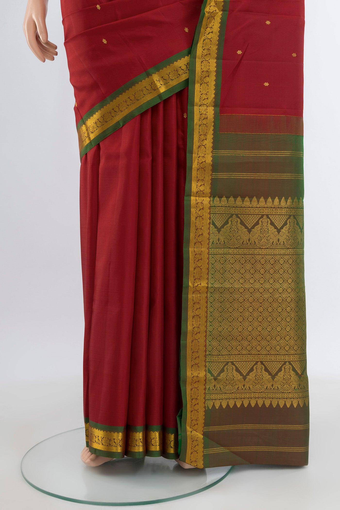 Pleats and pallu of Red Kanchipuram Silk Saree with Zari Butta on the body and Zari Border. 
