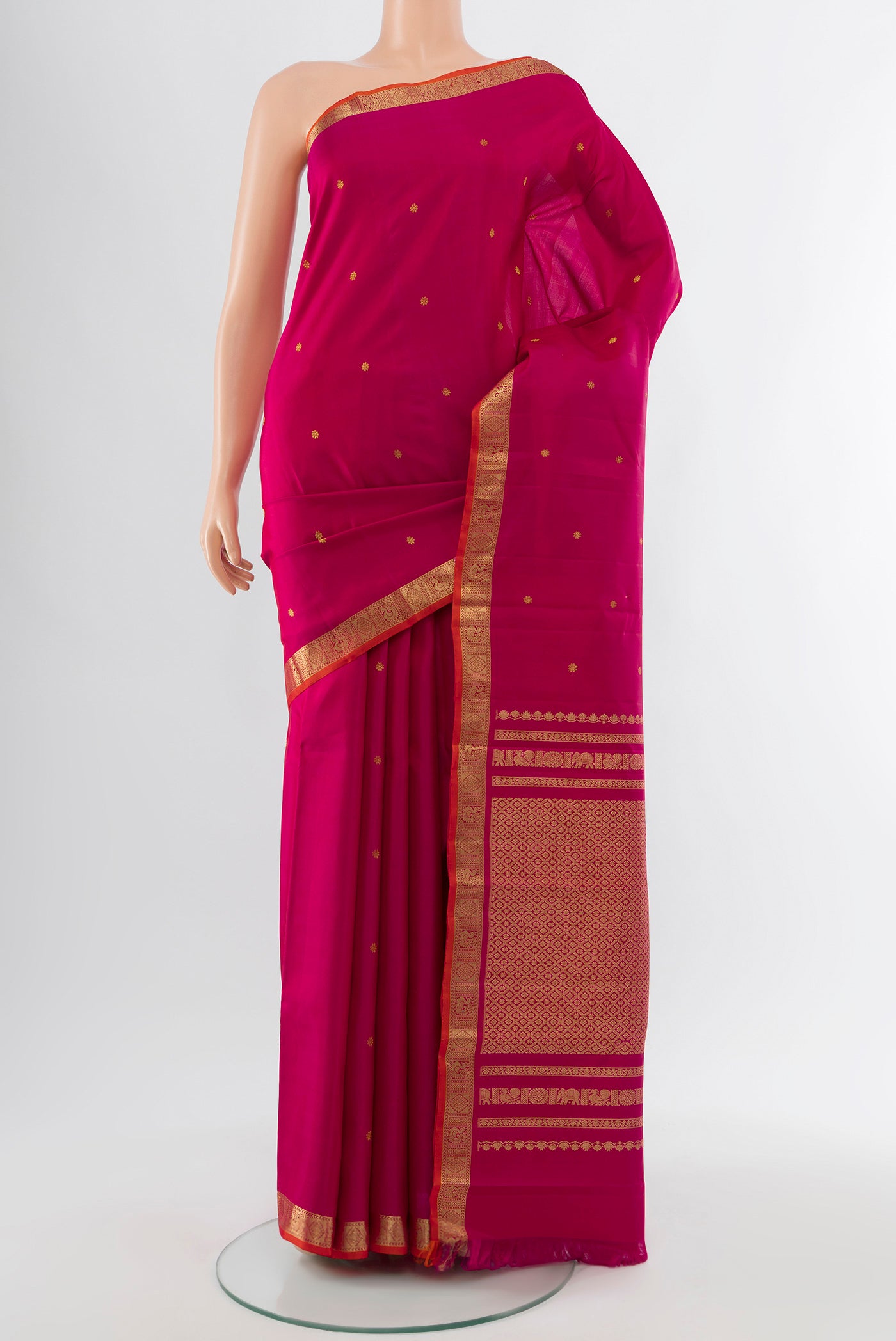 Dark Pink Kanchipuram Silk Saree with Zari Butta on the body and Silk Border.  displayed on a mannequin