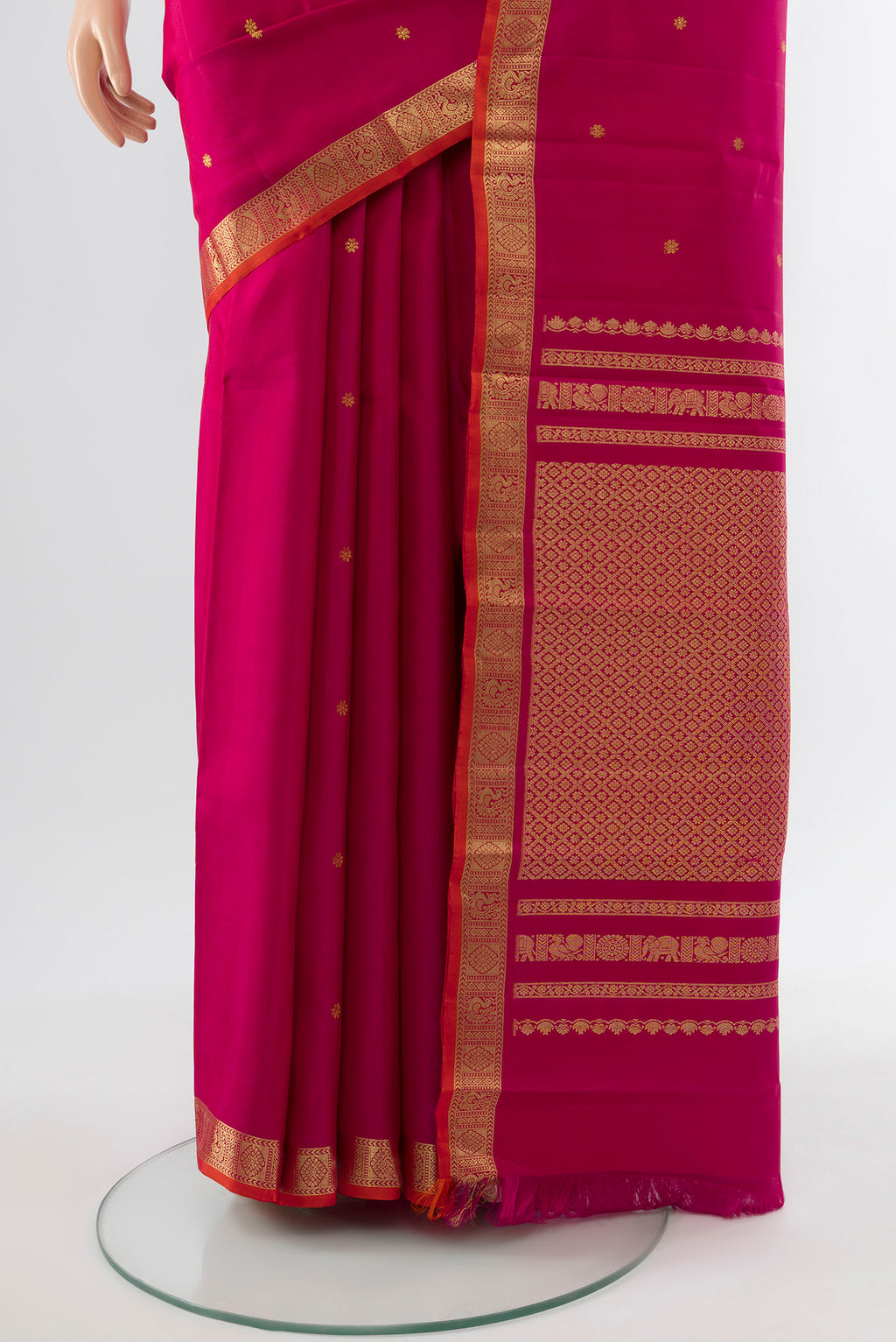 Pleats and pallu of Dark Pink Kanchipuram Silk Saree with Zari Butta on the body and Silk Border. 