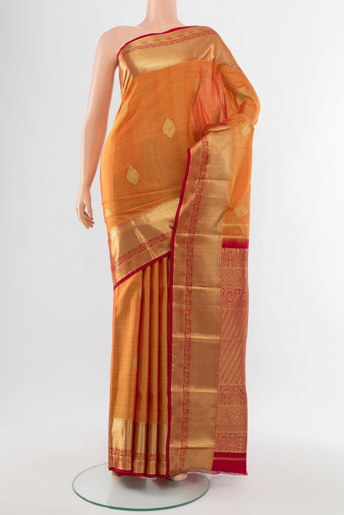 Pure Silk Pure Zari Mustard Kanchipuram Saree with Zari Butta on the body and Silk Border.  displayed on a mannequin