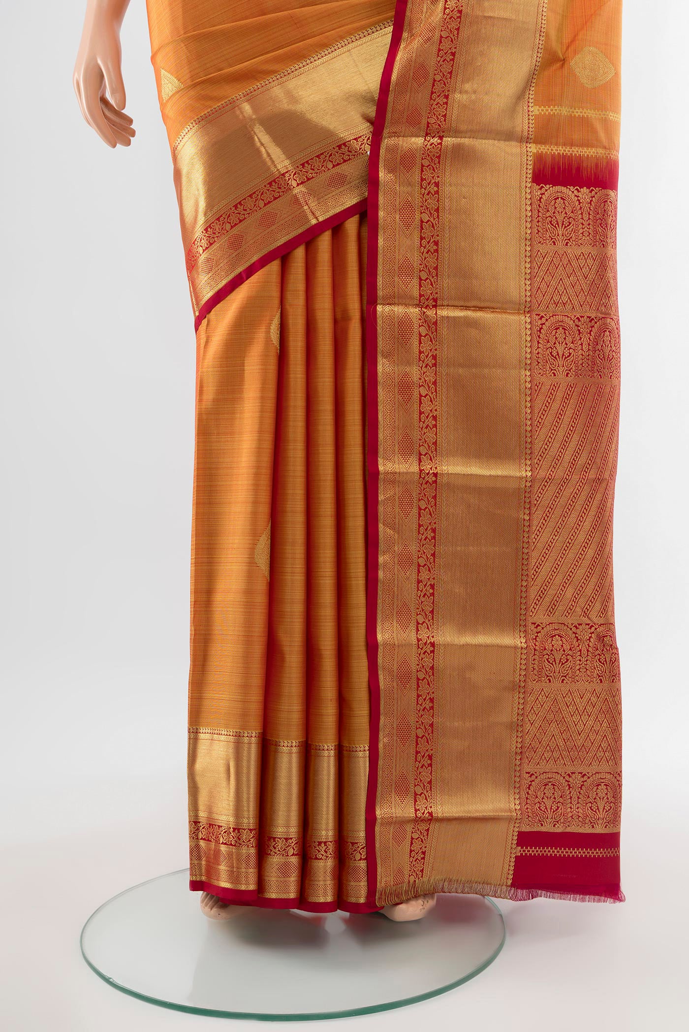 Pleats and pallu of Pure Silk Pure Zari Mustard Kanchipuram Saree with Zari Butta on the body and Silk Border. 