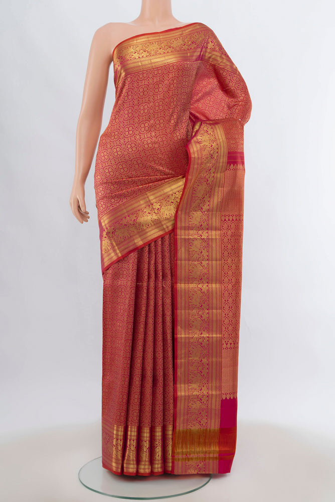 Peach Kanjivaram Silk Saree with Zari Brocade on the body and Silk Border.  displayed on a mannequin