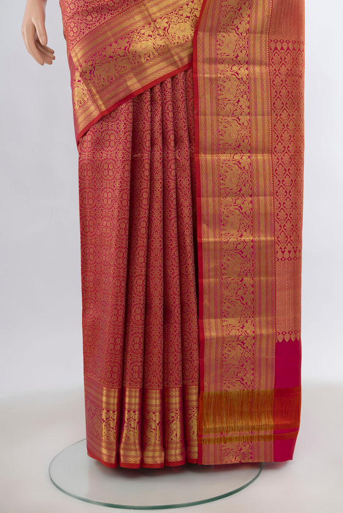 Pleats and pallu of Peach Kanjivaram Silk Saree with Zari Brocade on the body and Silk Border. 
