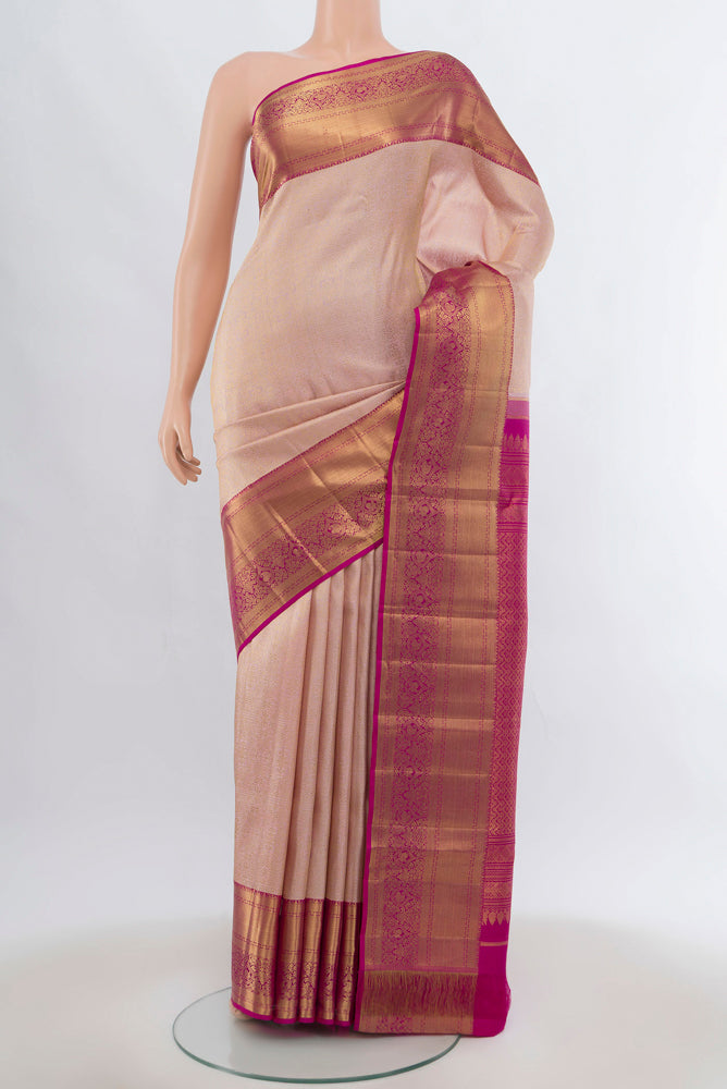 Golden Peach Kanchipuram Silk Saree with Zari Brocade on the body and Silk Border.  displayed on a mannequin