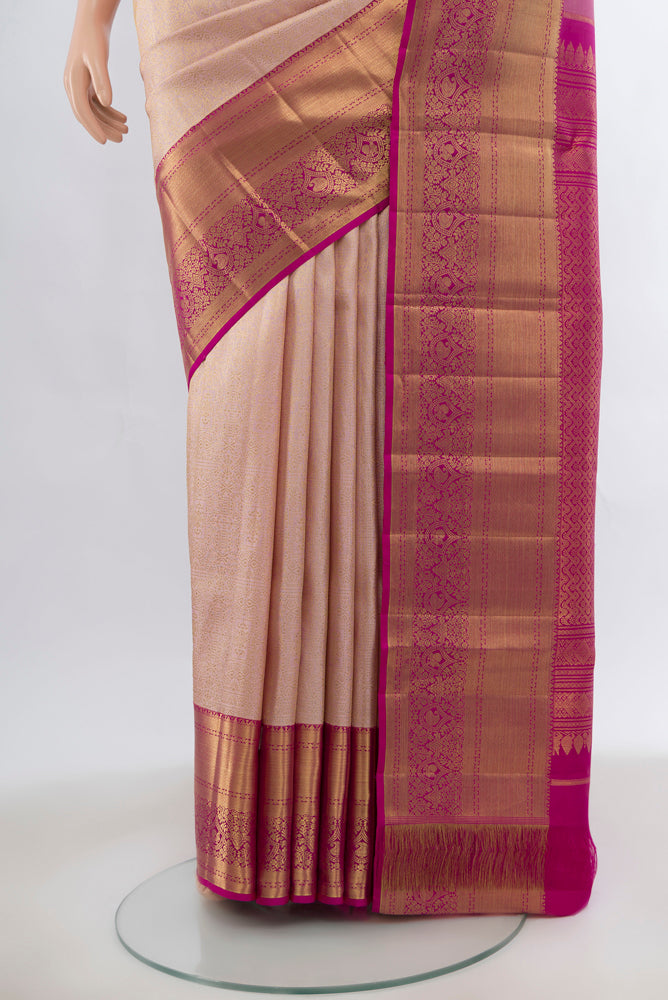 Pleats and pallu of Golden Peach Kanchipuram Silk Saree with Zari Brocade on the body and Silk Border. 
