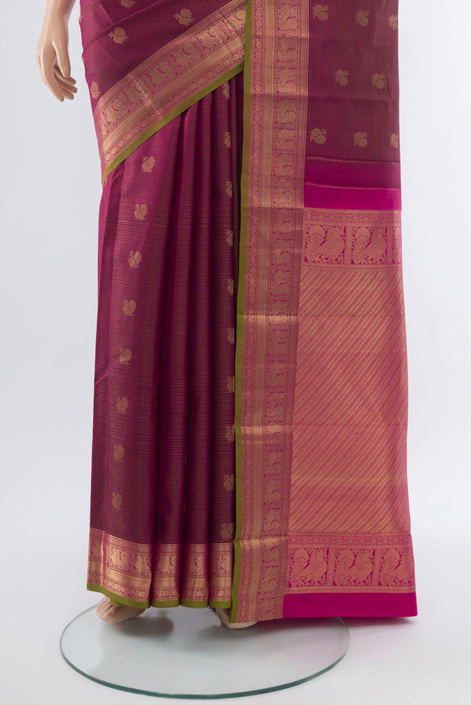 Pleats and pallu of Purple Kanchipuram Silk Saree with Zari Butta on the body and Silk Border. 