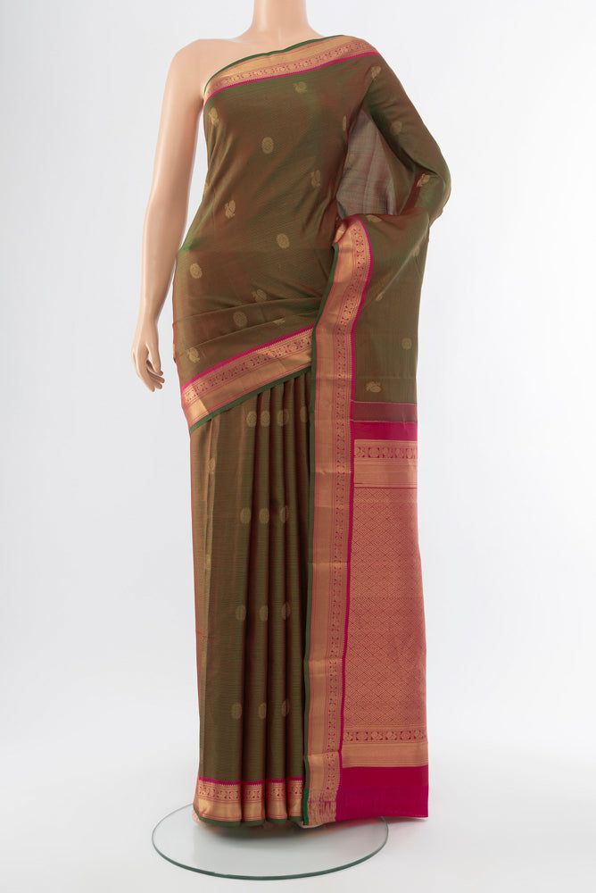 Mehandi Green Kanchipuram Silk Saree with Zari Butta on the body and Silk Border.  displayed on a mannequin