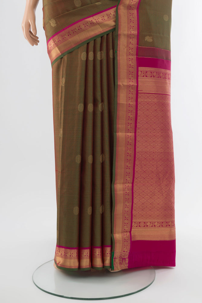 Pleats and pallu of Mehandi Green Kanchipuram Silk Saree with Zari Butta on the body and Silk Border. 