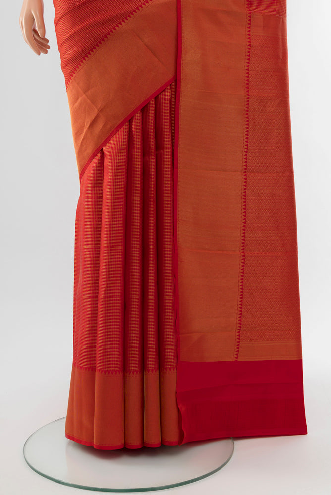 Pleats and pallu of Rust Kanchipuram Silk Saree with Zari Butta on the body and Silk Border. 