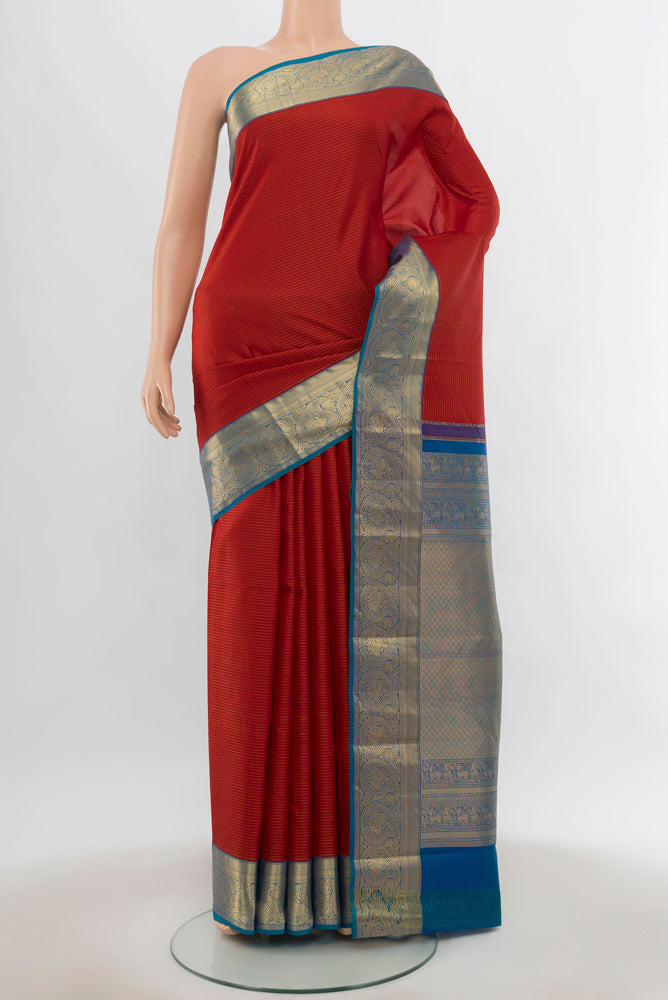 Maroon Kanchipuram Silk Saree with Zari Butta on the body and Silk Border.  displayed on a mannequin