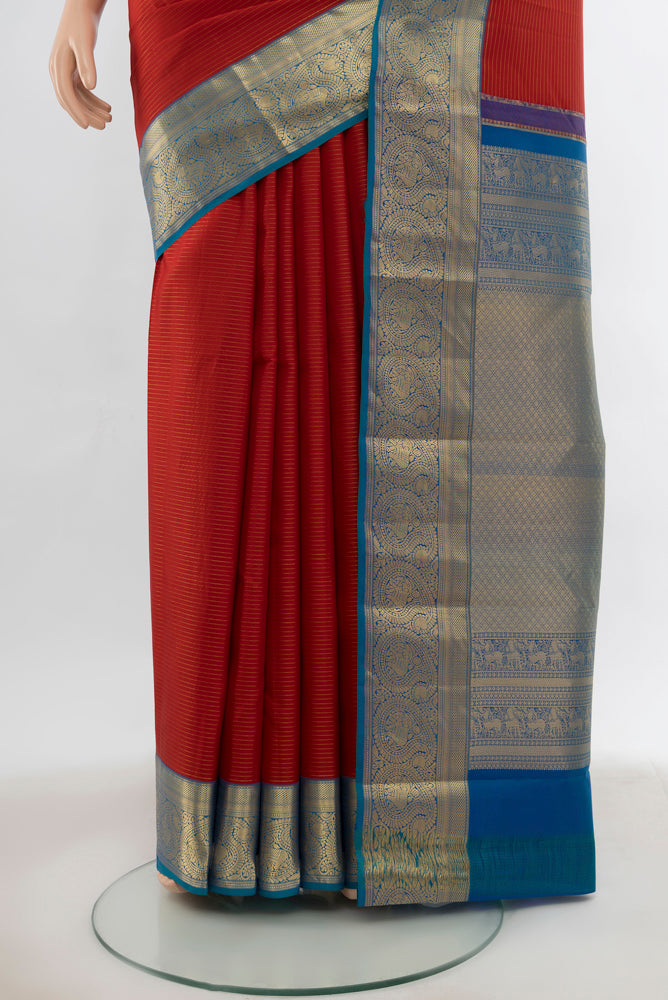 Pleats and pallu of Maroon Kanchipuram Silk Saree with Zari Butta on the body and Silk Border. 