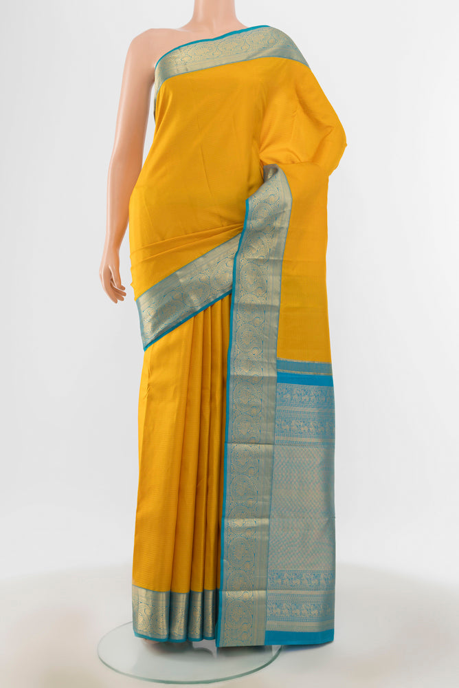 Yellow Kanchipuram Silk Saree with Zari Butta on the body and Silk Border.  displayed on a mannequin
