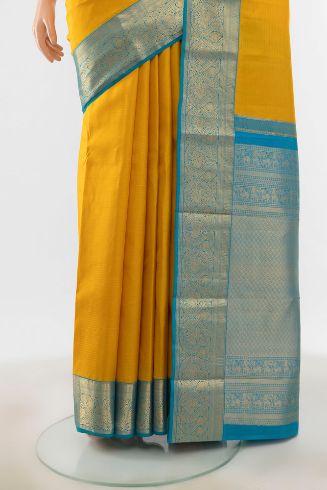 Pleats and pallu of Yellow Kanchipuram Silk Saree with Zari Butta on the body and Silk Border. 