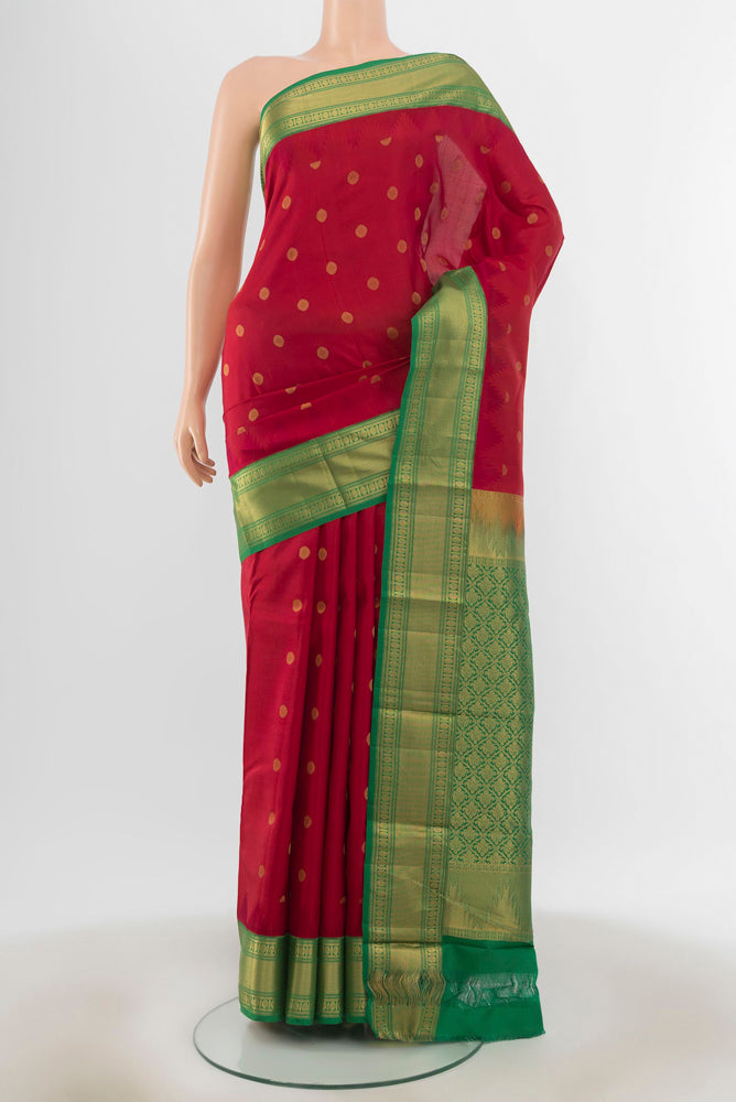 Maroon Kanchipuram Silk Saree with Zari Butta on the body and Silk Border.  displayed on a mannequin