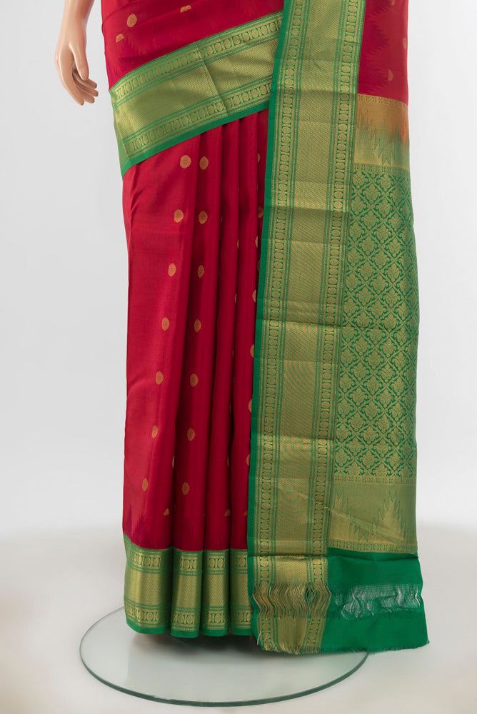 Pleats and pallu of Maroon Kanchipuram Silk Saree with Zari Butta on the body and Silk Border. 