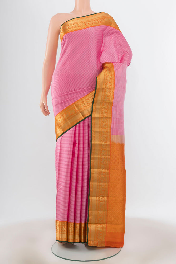 Rose pink Kanchipuram Silk Saree with Zari Butta on the body and Silk Border.  displayed on a mannequin