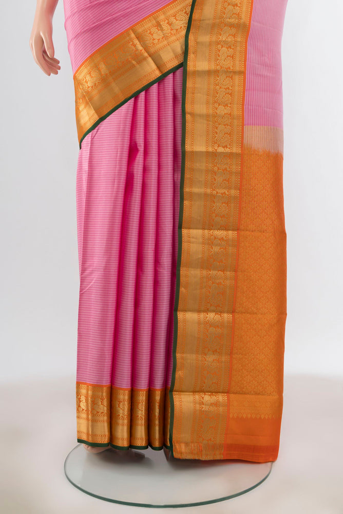 Pleats and pallu of Rose pink Kanchipuram Silk Saree with Zari Butta on the body and Silk Border. 