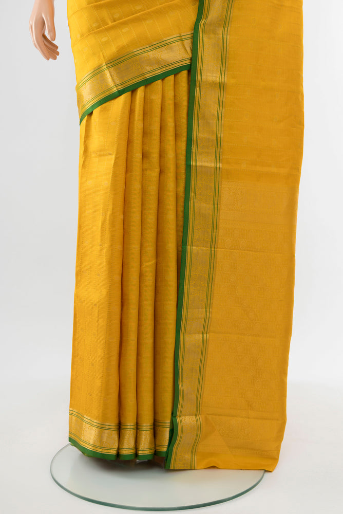 Pleats and pallu of Yellow Kanchipuram Silk Saree with Zari Butta on the body and Silk Border. 
