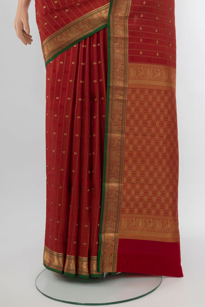 Pleats and pallu of Maroon Kanchipuram Silk Saree with Zari Butta on the body and Silk Border. 