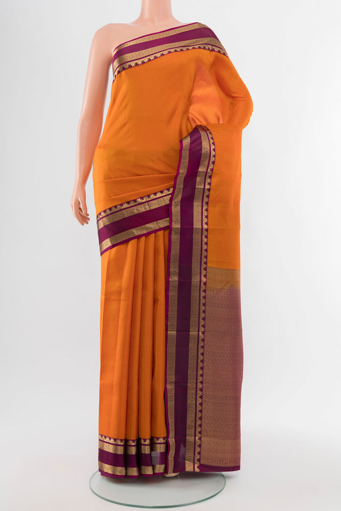 Brick Orange Kanchipuram Silk Saree with Zari Butta on the body and Silk Border.  displayed on a mannequin