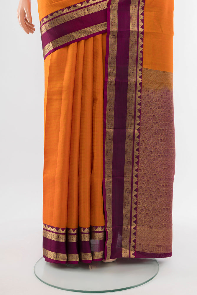 Pleats and pallu of Brick Orange Kanchipuram Silk Saree with Zari Butta on the body and Silk Border. 