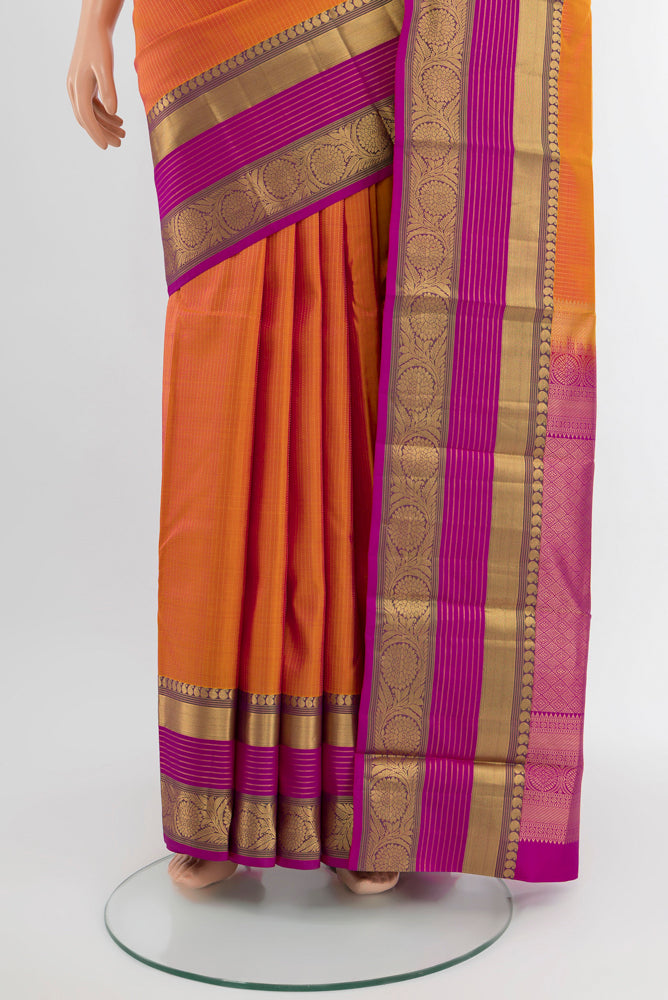 Pleats and pallu of Golden Peach Kanjivaram Silk Saree with Zari Butta on the body and Silk Border. 