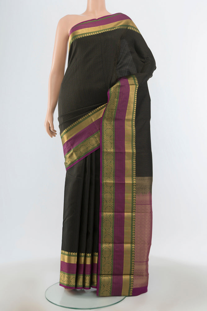 Black Kanjivaram Silk Saree with Zari Butta on the body and Silk Border.  displayed on a mannequin