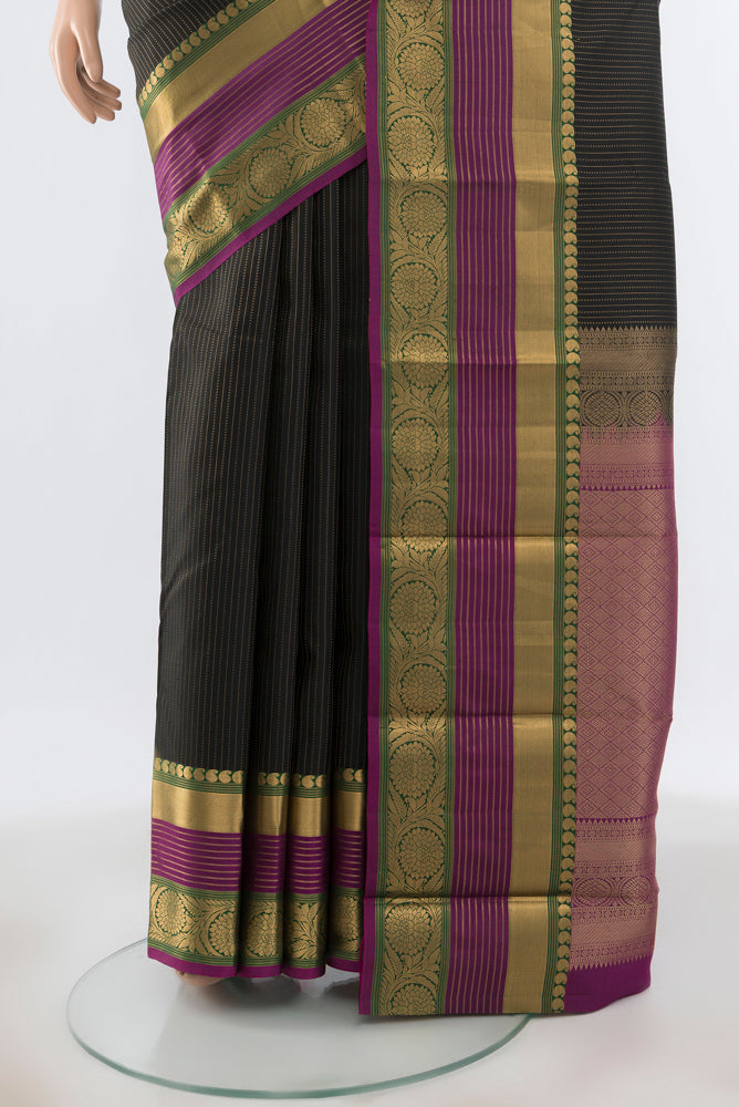 Pleats and pallu of Black Kanjivaram Silk Saree with Zari Butta on the body and Silk Border. 