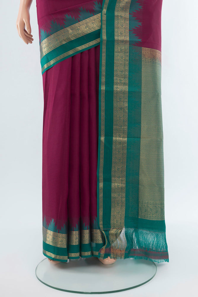Pleats and pallu of Maroon Kanchipuram Silk Saree with Zari Butta on the body and Silk Border. 