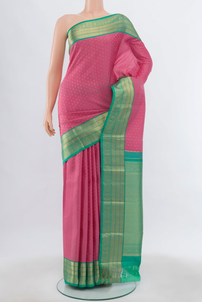 Rose pink Kanchipuram Silk Saree with Zari Butta on the body and Silk Border.  displayed on a mannequin