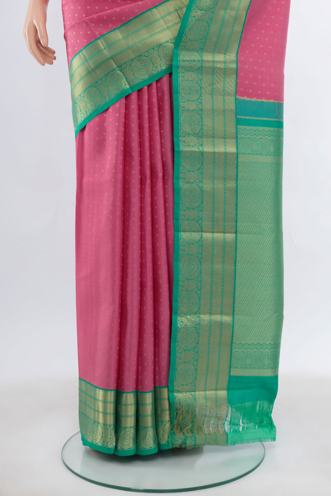 Pleats and pallu of Rose pink Kanchipuram Silk Saree with Zari Butta on the body and Silk Border. 