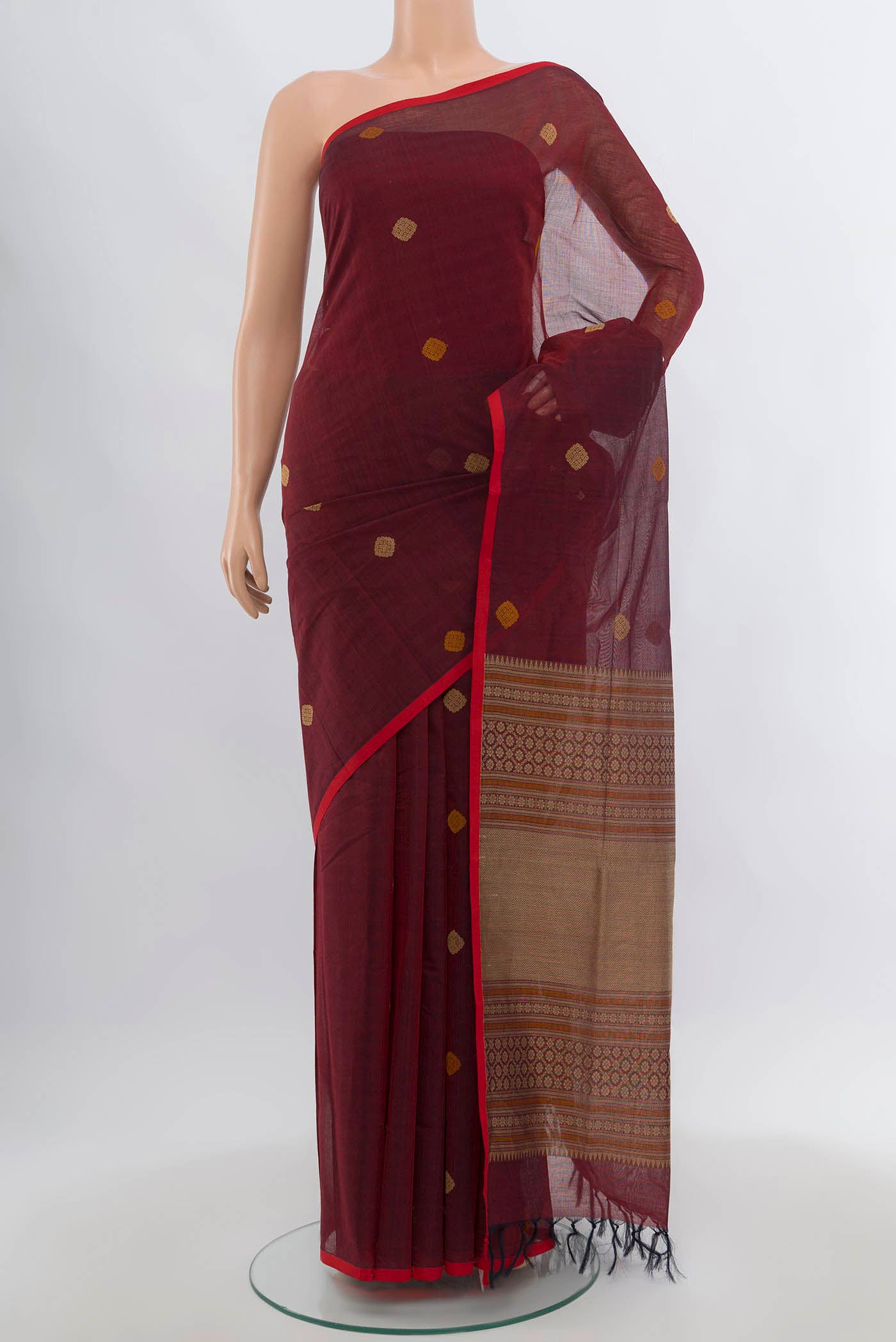 Maroon Coimbatore Cotton Saree with Thread Butta on the body and Thread Border.  displayed on a mannequin