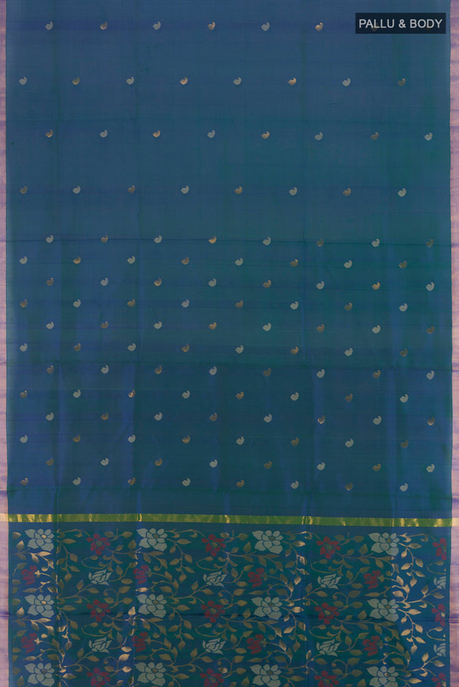 Flat view of Peacock Blue Uppada Silk Saree with Zari Butta on the body and Silk Border. 