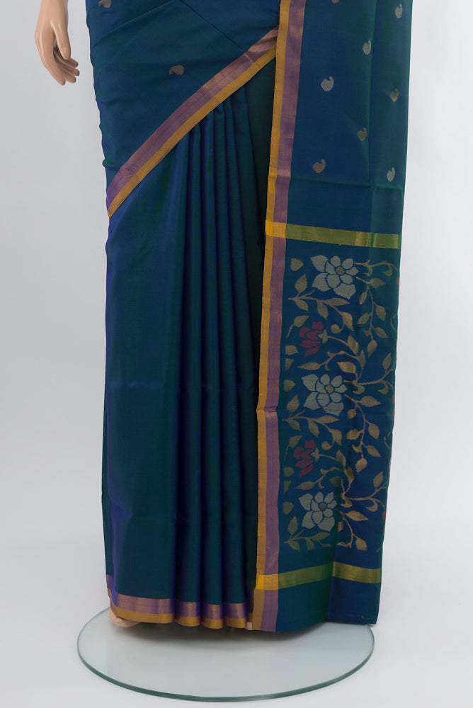 Pleats and pallu of Peacock Blue Uppada Silk Saree with Zari Butta on the body and Silk Border. 