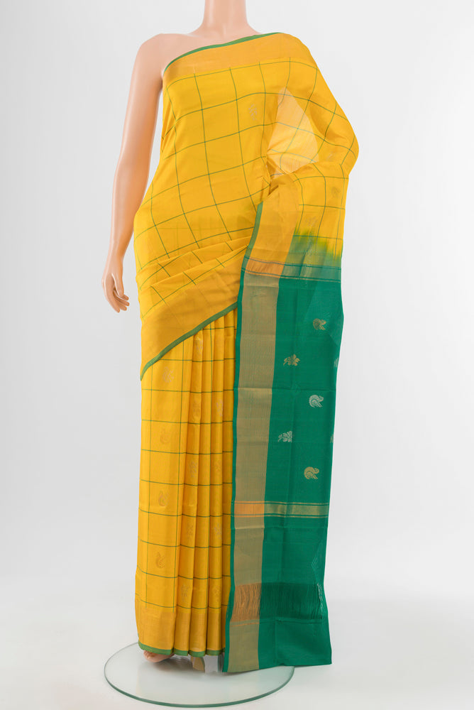 Yellow Uppada Silk Saree with Zari Butta on the body and Silk Border.  displayed on a mannequin