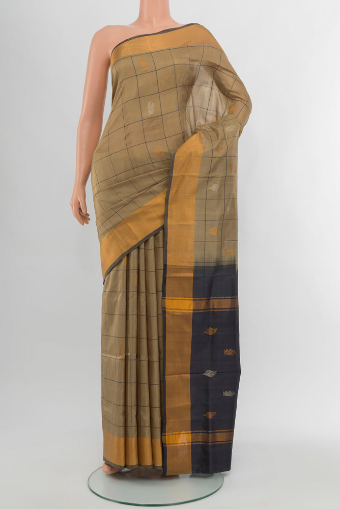 Dark Beige Uppada Silk Saree with Zari Butta on the body and Silk Border.  displayed on a mannequin