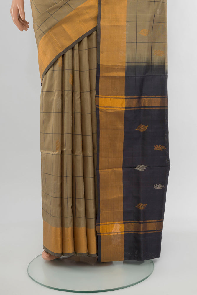 Pleats and pallu of Dark Beige Uppada Silk Saree with Zari Butta on the body and Silk Border. 