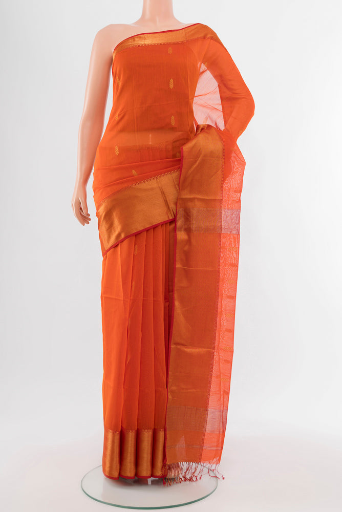 Orange Maheshwari Silk Cotton Saree with Zari Butta on the body and Silk Border.  displayed on a mannequin
