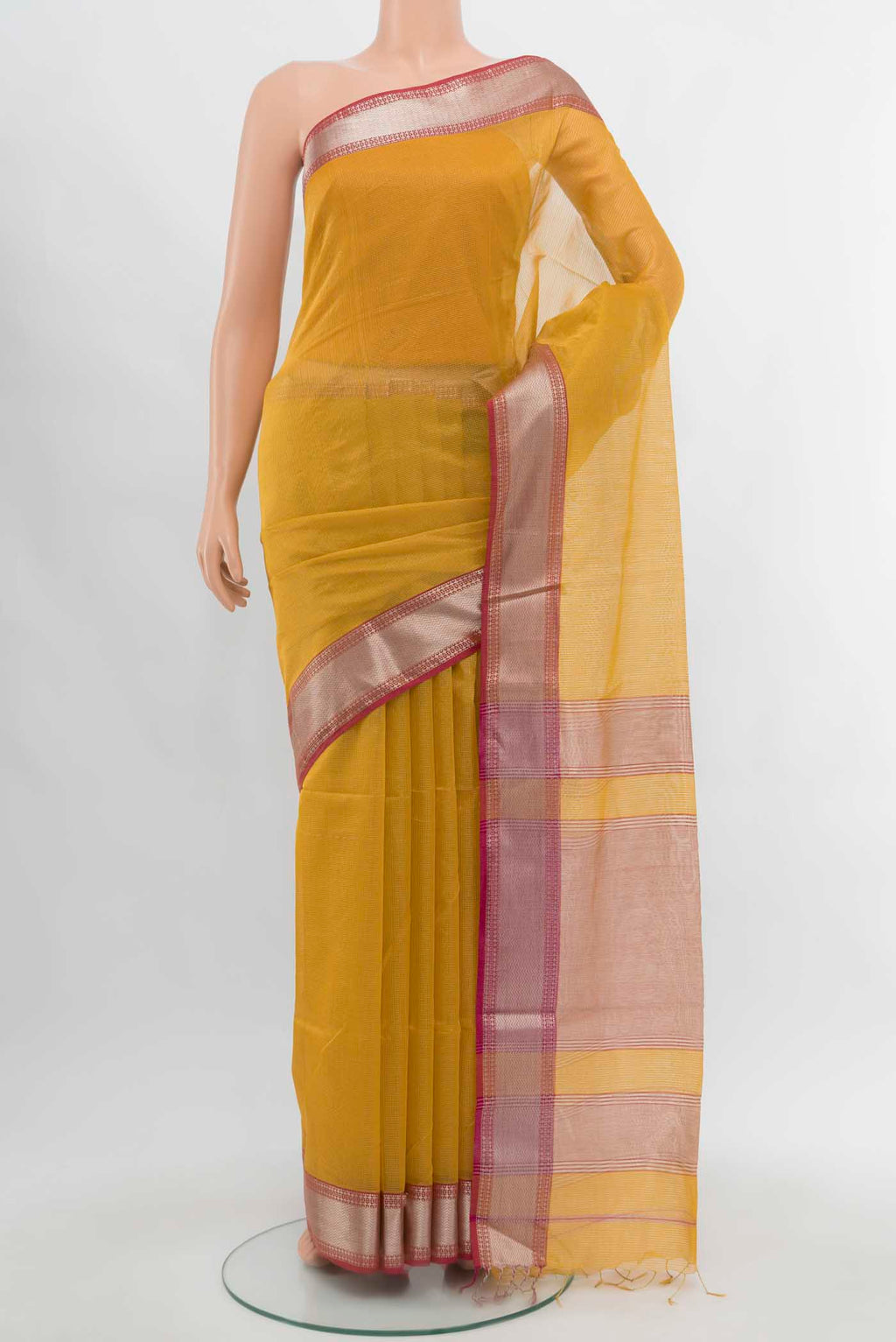 Mustard Maheshwari Silk Cotton Saree with Zari Butta on the body and Silk Border.  displayed on a mannequin