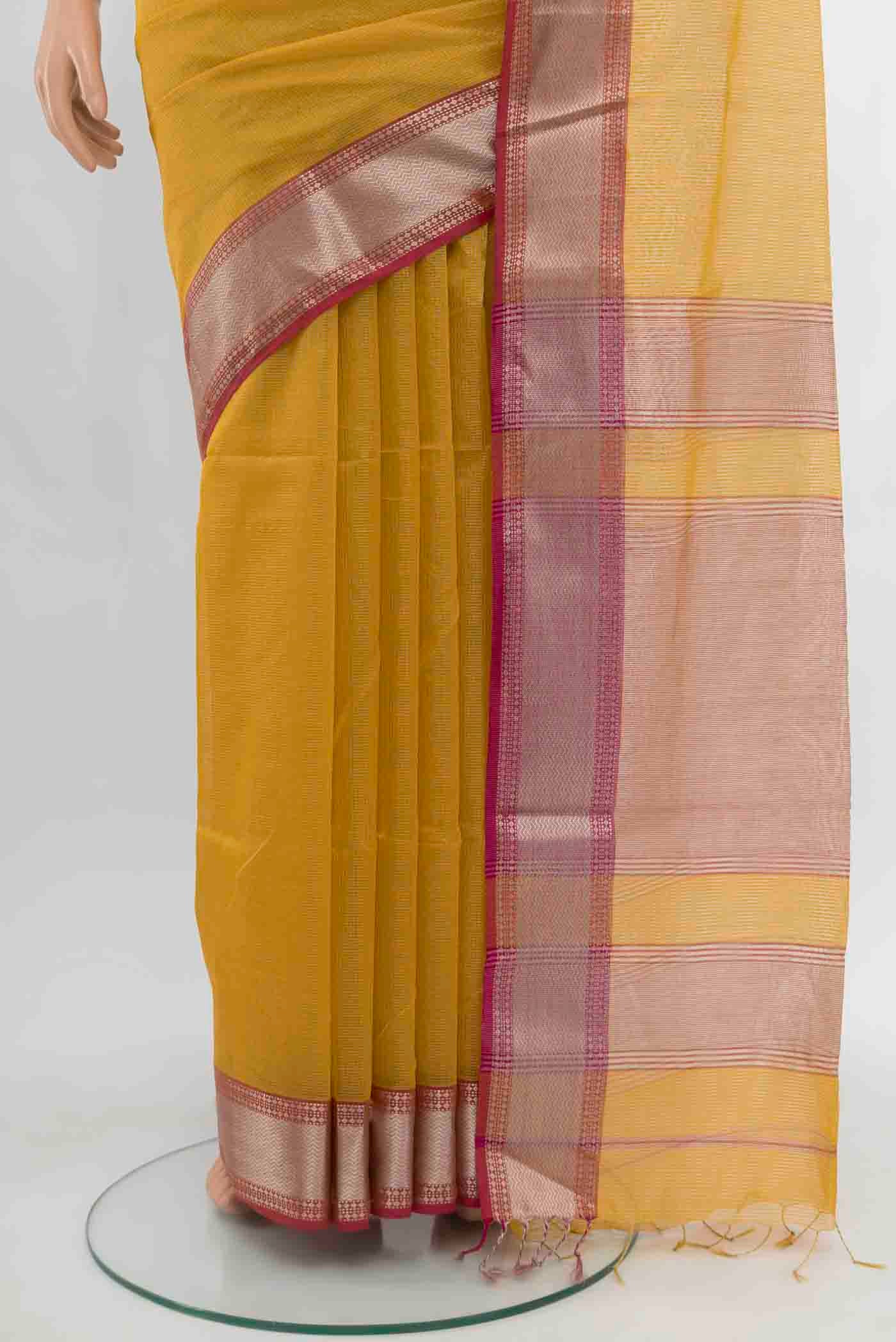 Pleats and pallu of Mustard Maheshwari Silk Cotton Saree with Zari Butta on the body and Silk Border. 