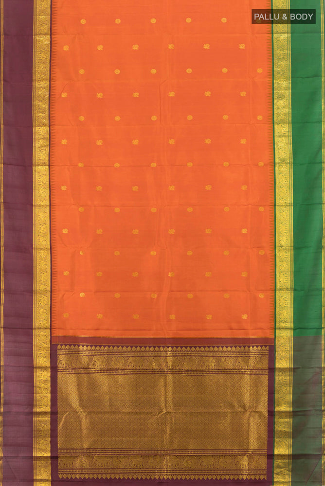 Flat view of Pure Silk Pure Zari Rust Kanjivaram Saree with Zari Butta on the body and Silk Border. 