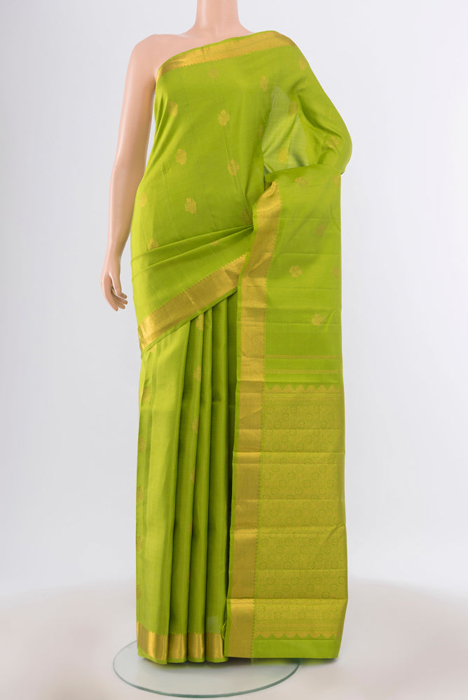 Pure Silk Pure Zari Parrot Green Kanjivaram Saree with Zari Butta on the body and Silk Border.  displayed on a mannequin