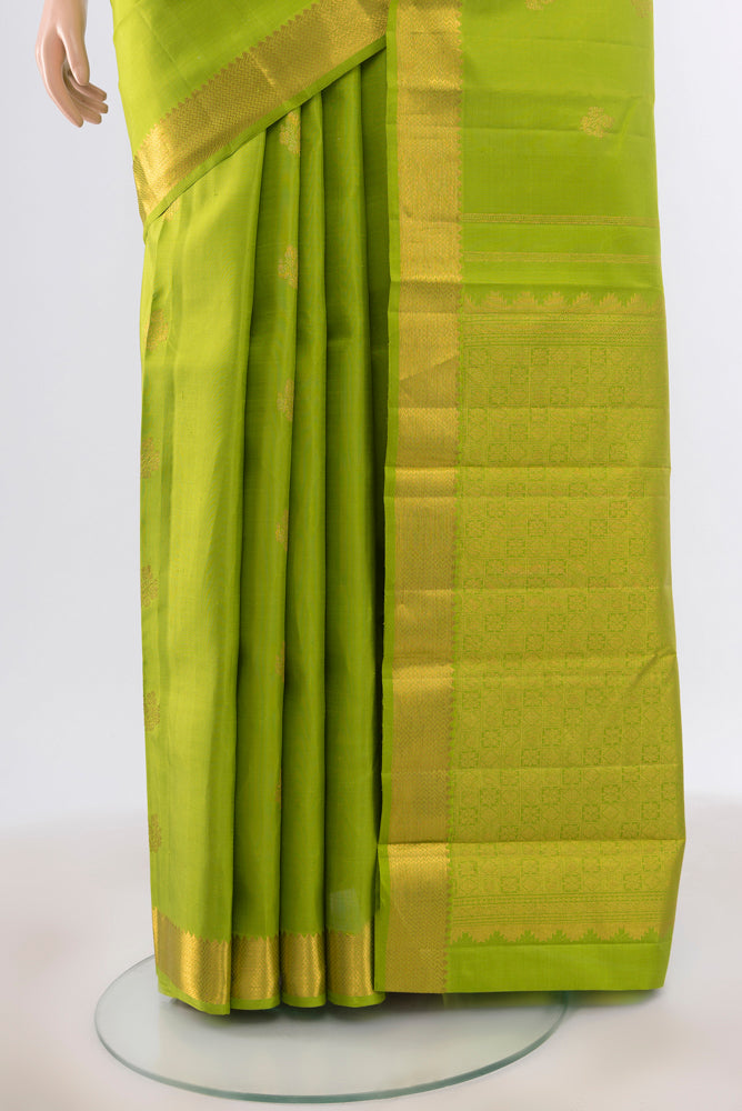 Pleats and pallu of Pure Silk Pure Zari Parrot Green Kanjivaram Saree with Zari Butta on the body and Silk Border. 