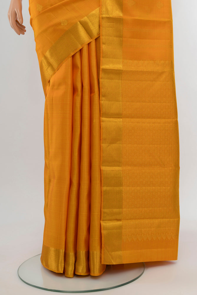 Pleats and pallu of Mustard Kanjivaram Silk Saree with Zari Butta on the body and Silk Border. 