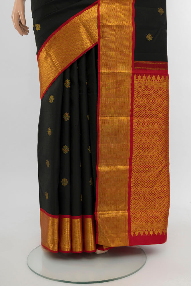 Pleats and pallu of Black Kanjivaram Silk Saree with Zari Butta on the body and Silk Border. 