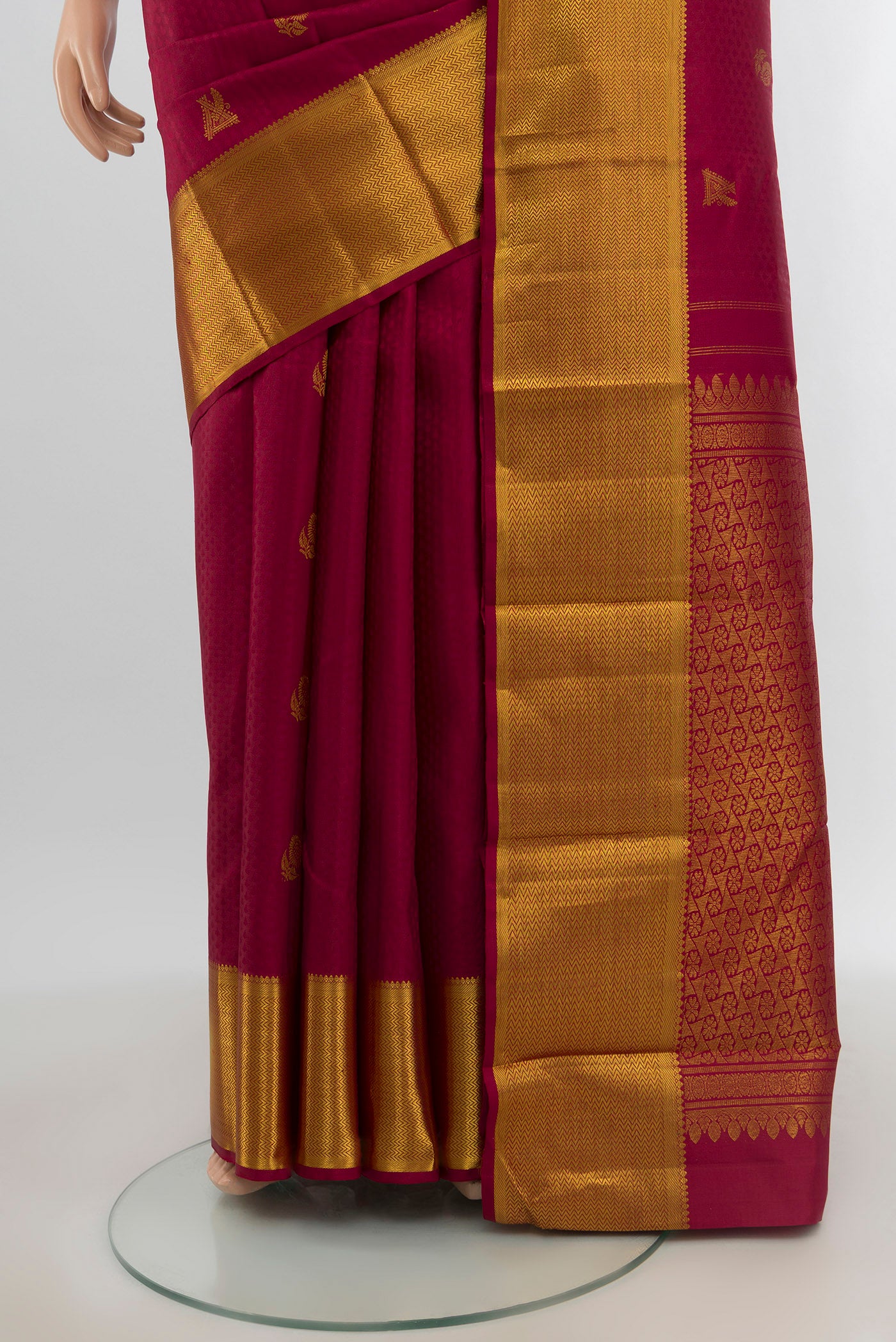 Pleats and pallu of Maroon Kanjivaram Silk Saree with Zari Butta on the body and Zari Border. 