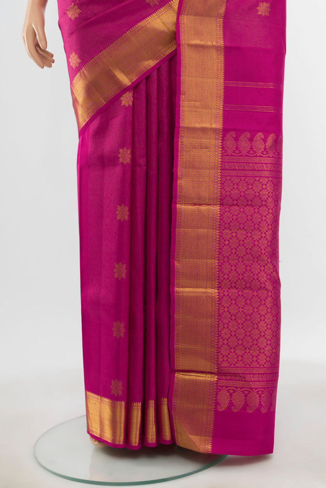 Pleats and pallu of Pure Silk Pure Zari Magenta Kanjivaram Saree with Zari Butta on the body and Silk Border. 